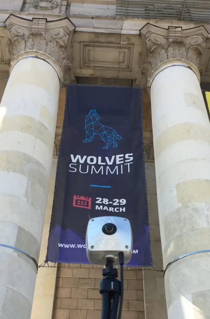 Veye camera in front of a wolves summit banner