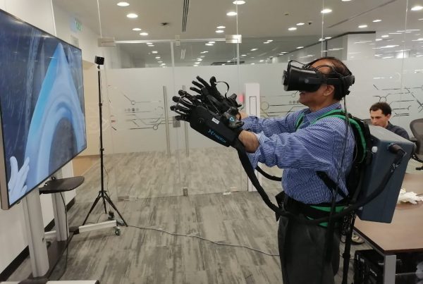 man trying out VR with advanced VR gloves