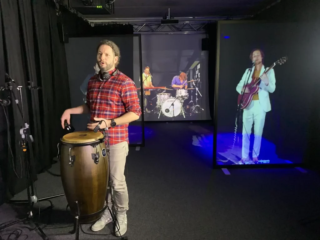 Live performance of a band with half of the musicians being holograms