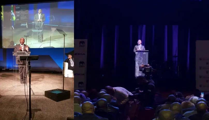 South African president talking on a podium and being streamed as a hologram for a crowd in an other location